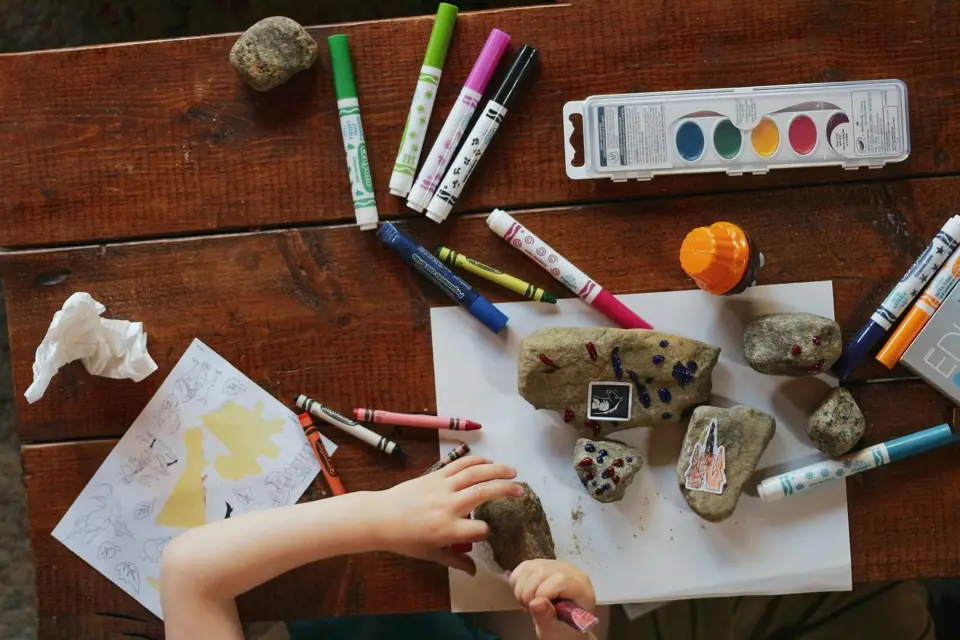 Kids painting at a craft table on the farm